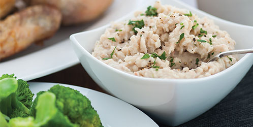 Roast chicken with white bean mash in a bowl