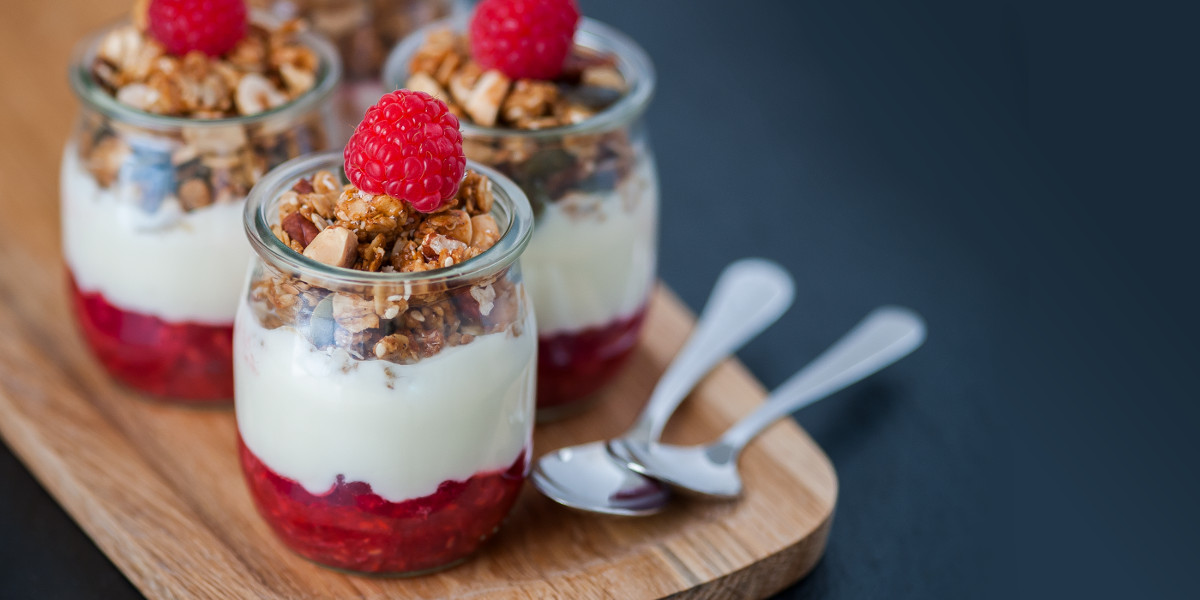 Yoghurt with crushed raspberry and granola in single serving pots